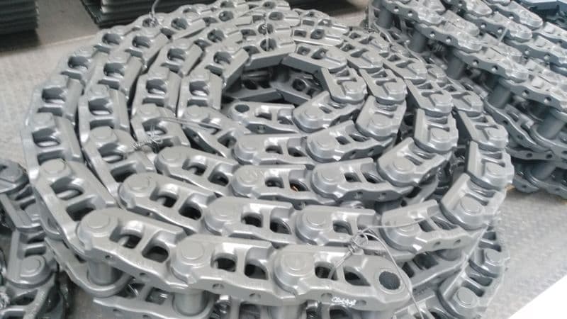 Excavator track chain coiled in multiple loops